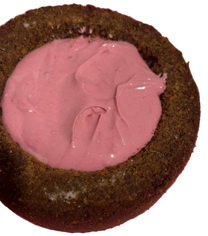 Chocolate cake with pink frosting on a pink measuring mat